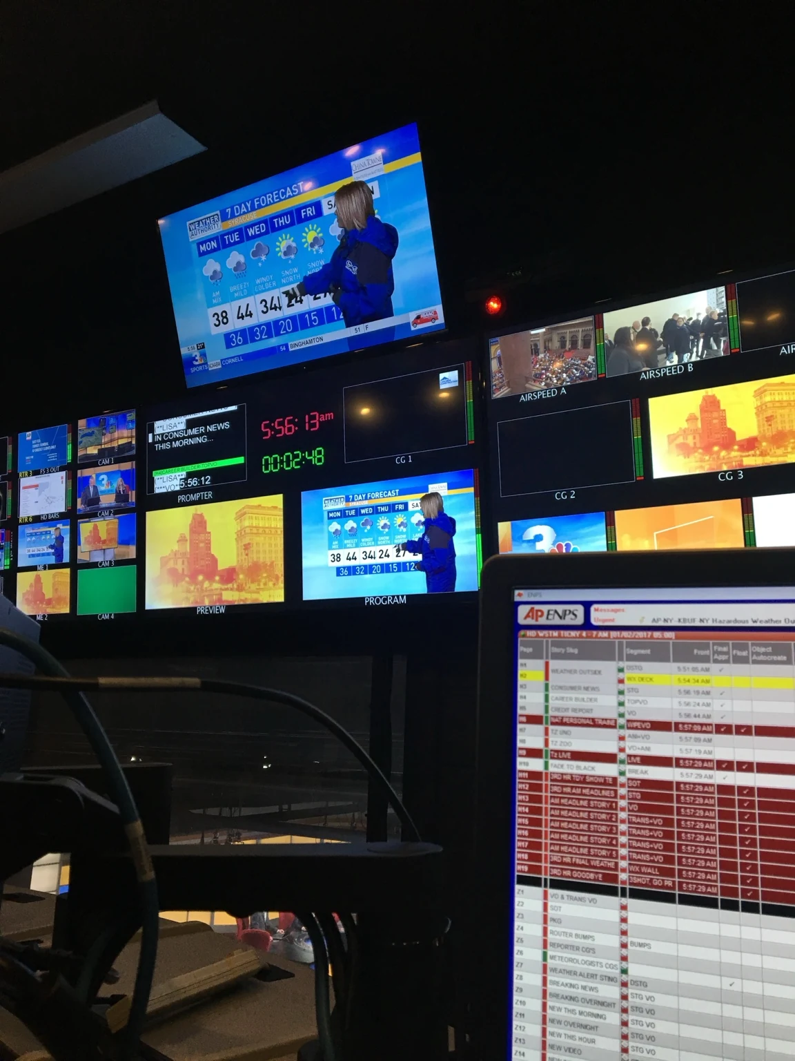 CNYCentral Syracuse control room showing program and weather monitors above a newsroom rundown workstation