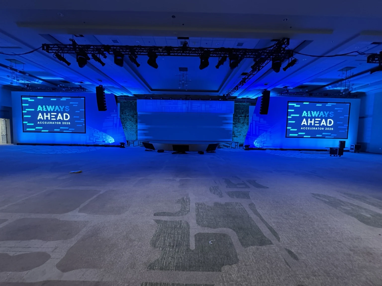 AHEAD Accelerator 2026 stage-ready ballroom with presentation screens, suspended lighting and an unoccupied floor